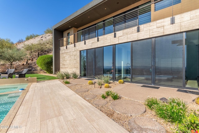 back of house with a patio and a swimming pool