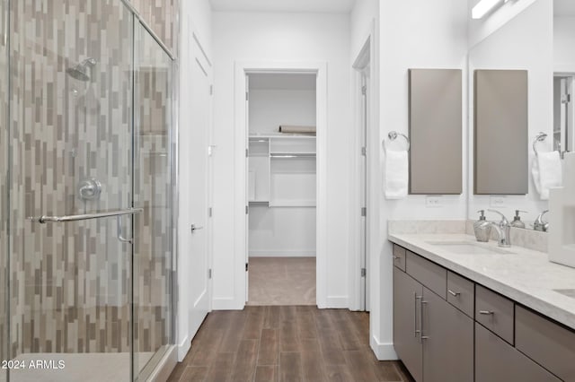 bathroom featuring vanity and a shower with shower door