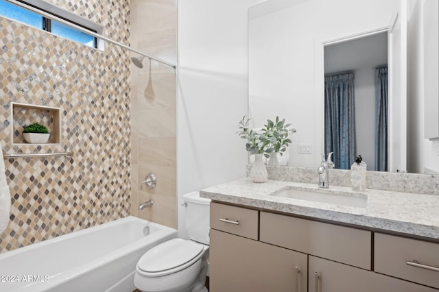 full bathroom with vanity, tiled shower / bath combo, and toilet