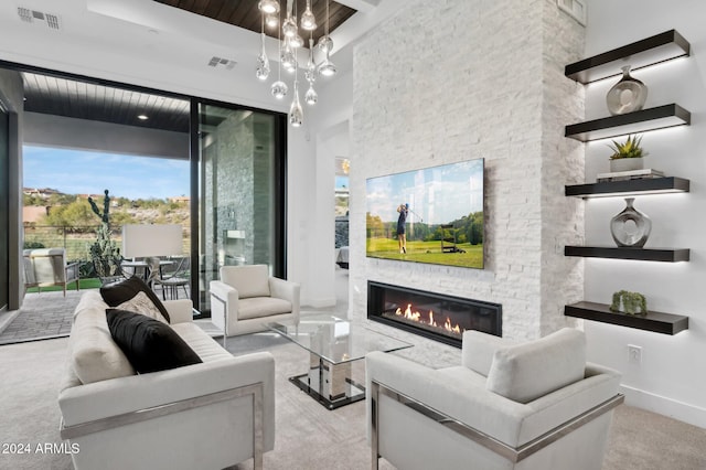 carpeted living room with a fireplace and a towering ceiling