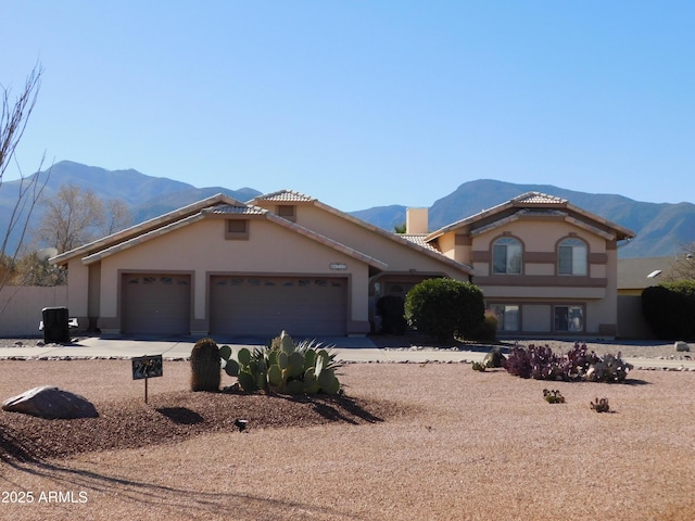 view of front of home featuring a mountain view and a garage