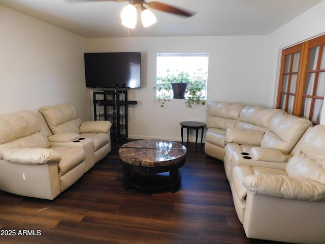 living room featuring ceiling fan and dark wood-type flooring