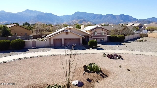 view of front of property featuring a mountain view and a garage