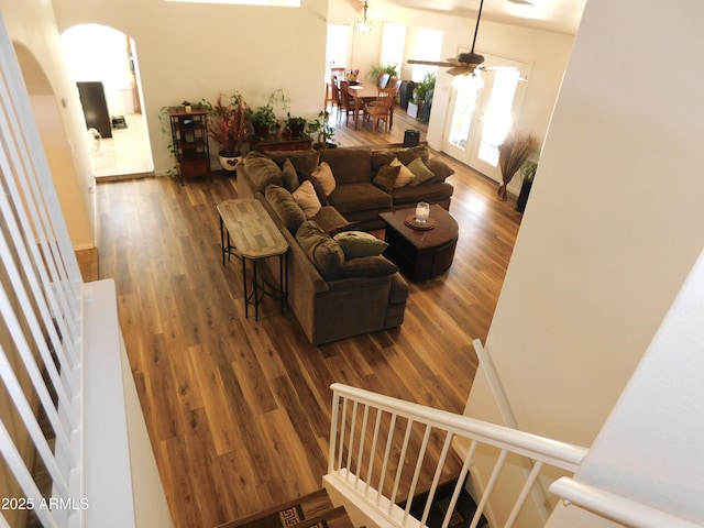 living room featuring wood-type flooring, french doors, and ceiling fan