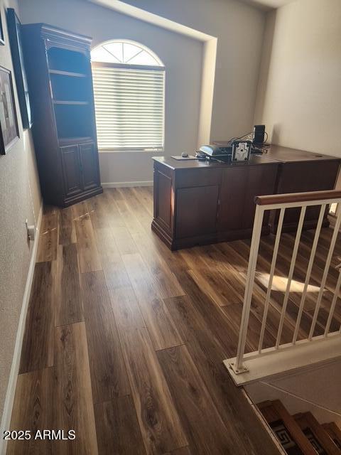 unfurnished office featuring dark hardwood / wood-style floors