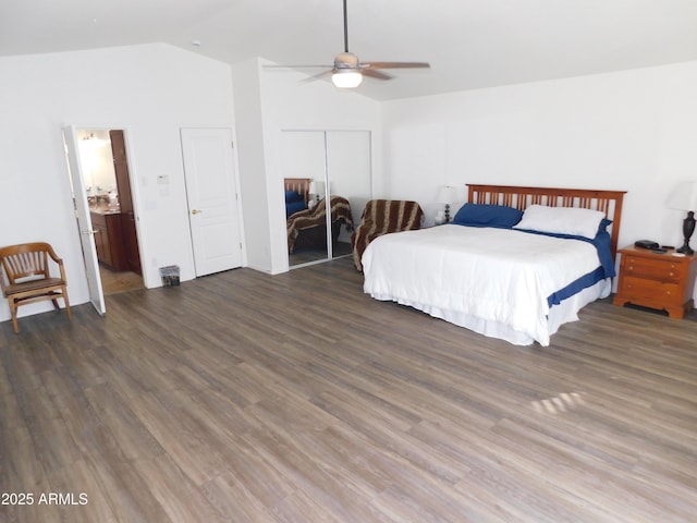 bedroom with ceiling fan, a closet, dark wood-type flooring, and lofted ceiling