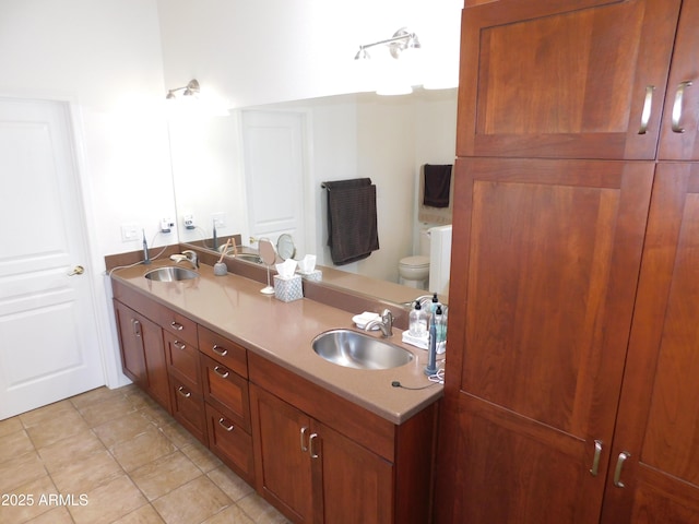 bathroom featuring tile patterned flooring, vanity, and toilet