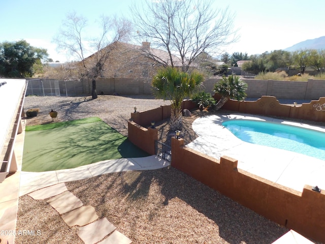 view of swimming pool with a mountain view