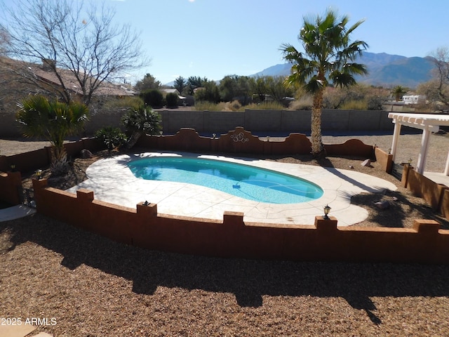 view of pool with a mountain view and a patio area