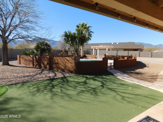 view of yard with a mountain view and a pergola