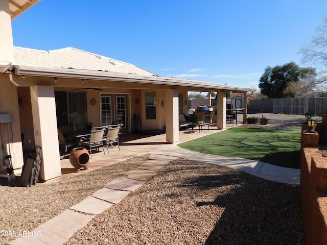 back of house featuring ceiling fan, french doors, and a patio