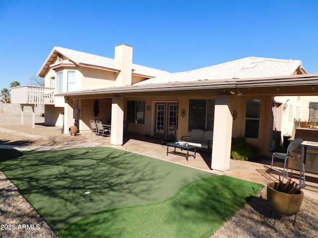 rear view of house featuring a patio and an outdoor hangout area