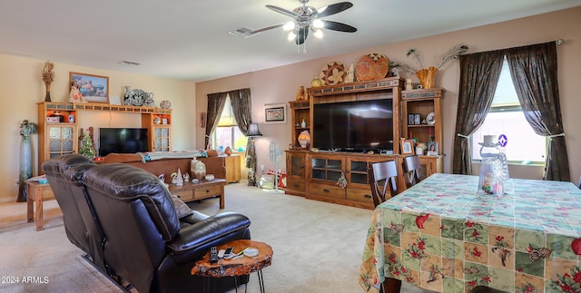 living room with ceiling fan and light colored carpet