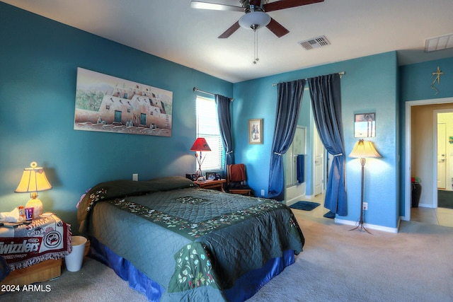 bedroom featuring ensuite bathroom, ceiling fan, and light colored carpet