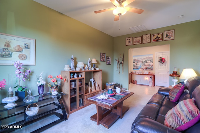 carpeted living room with ceiling fan