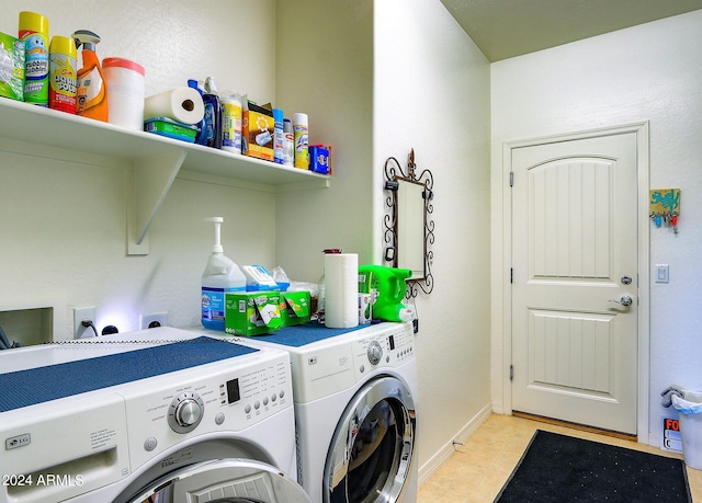 clothes washing area with independent washer and dryer and light tile patterned floors