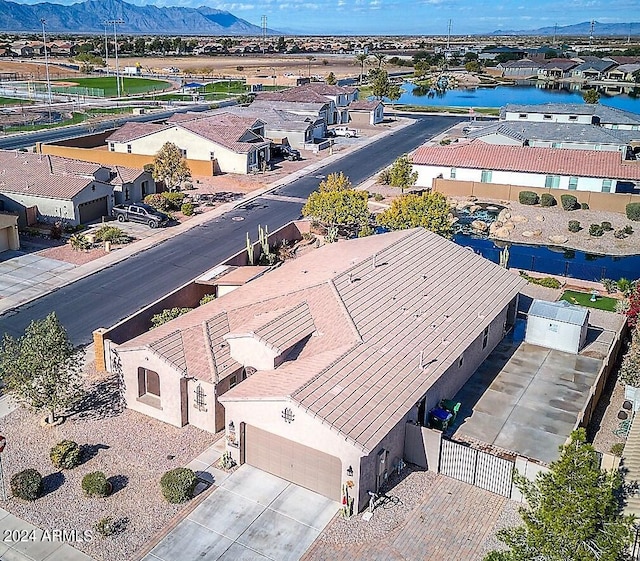 birds eye view of property with a water and mountain view