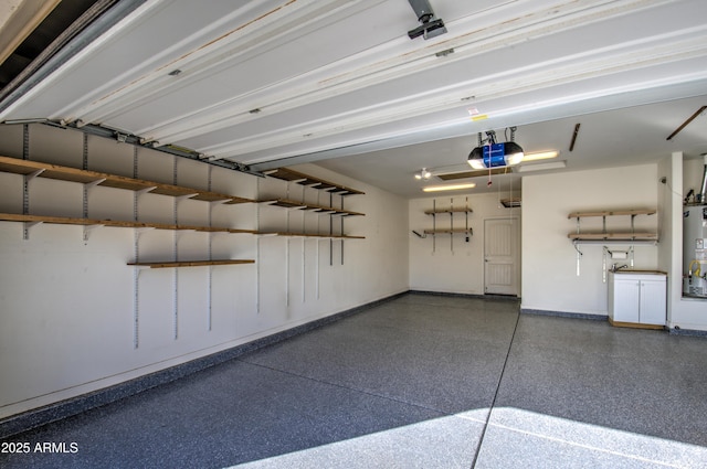 garage featuring gas water heater and a garage door opener