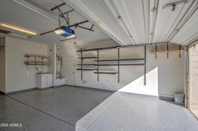 garage with water heater and a garage door opener