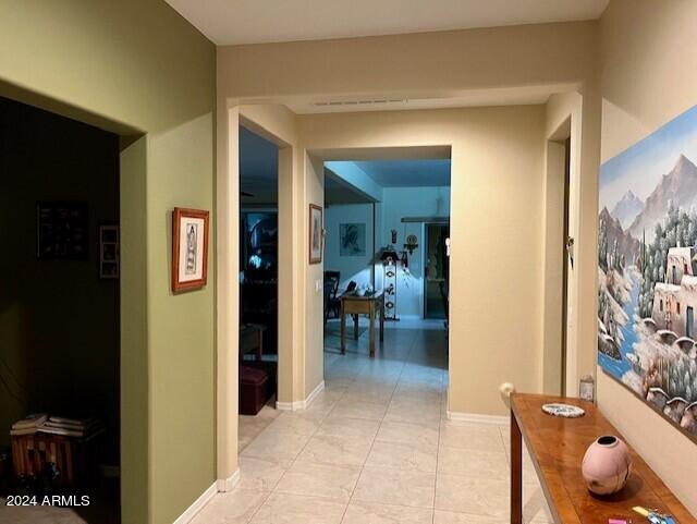 hall with light tile patterned floors