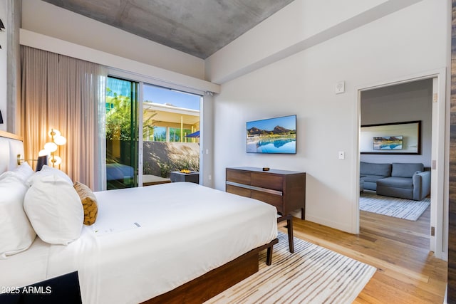 bedroom with access to exterior and light wood-type flooring