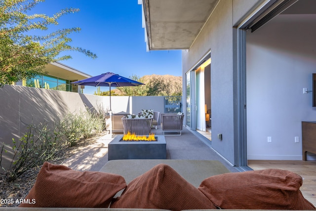 view of patio / terrace featuring an outdoor fire pit