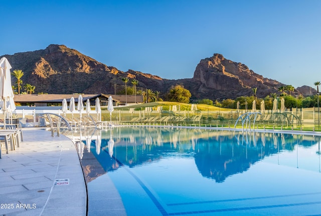 view of swimming pool with a mountain view and a patio area