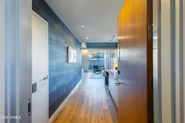 hallway with light hardwood / wood-style floors