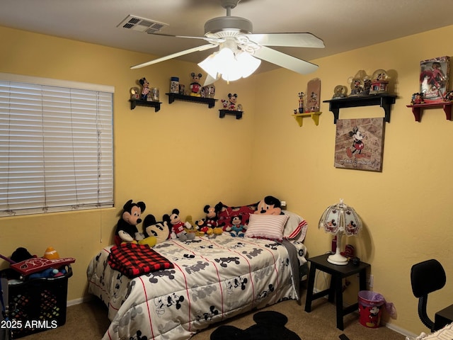 carpeted bedroom with visible vents and ceiling fan