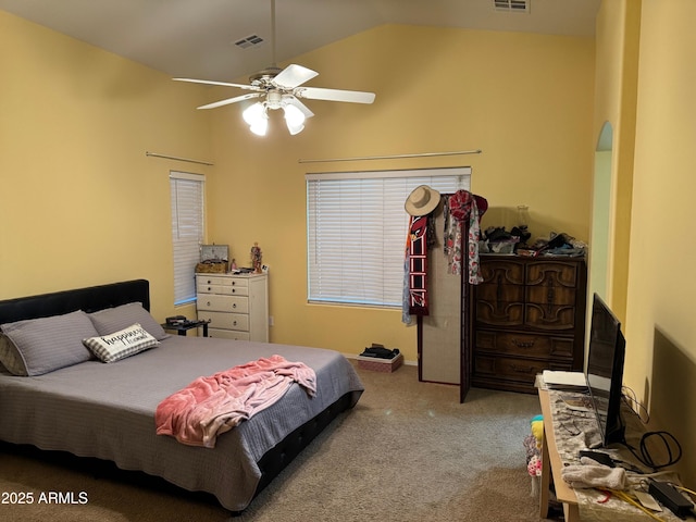 carpeted bedroom with visible vents, lofted ceiling, and a ceiling fan