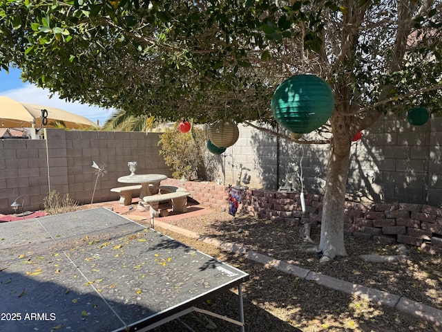 exterior space with a fenced backyard and a patio area