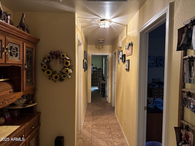 corridor with light tile patterned floors