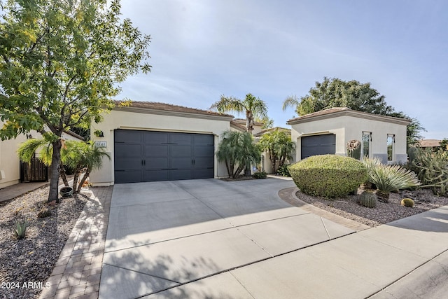 mediterranean / spanish-style home with a garage