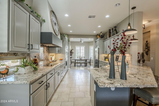 kitchen with pendant lighting, black electric stovetop, ceiling fan, gray cabinets, and light tile patterned floors