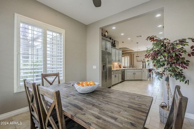 dining room featuring ceiling fan and a healthy amount of sunlight