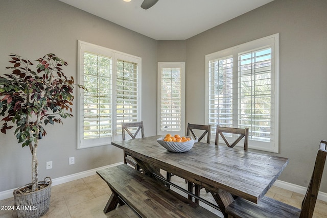 dining space with plenty of natural light, light tile patterned flooring, and ceiling fan