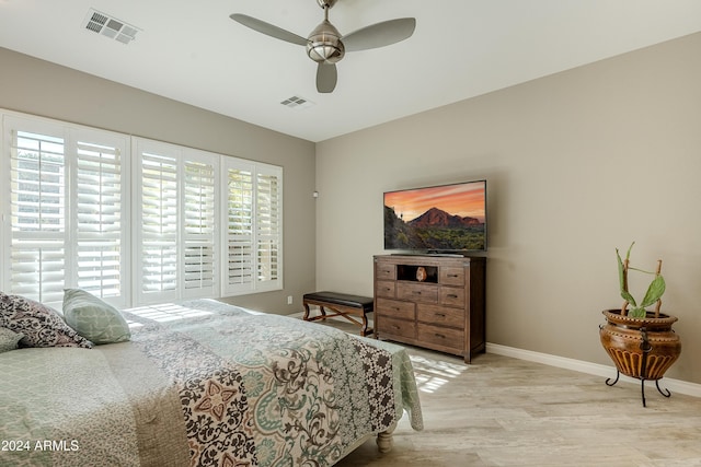 bedroom with light hardwood / wood-style floors and ceiling fan