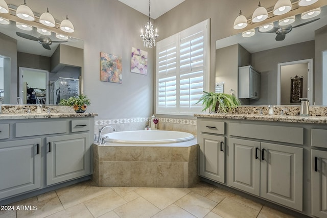 bathroom with a chandelier, vanity, and independent shower and bath