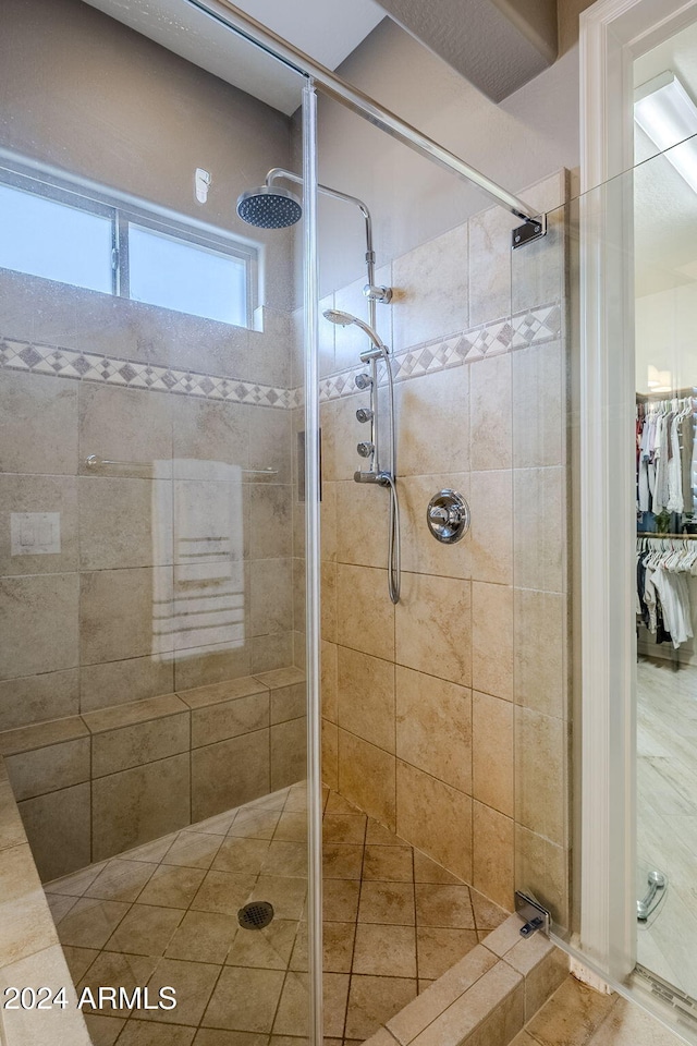 bathroom with tiled shower