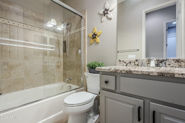 full bathroom with vanity, toilet, and enclosed tub / shower combo