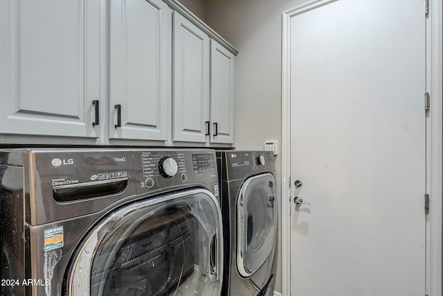 laundry area with cabinets and washer and clothes dryer