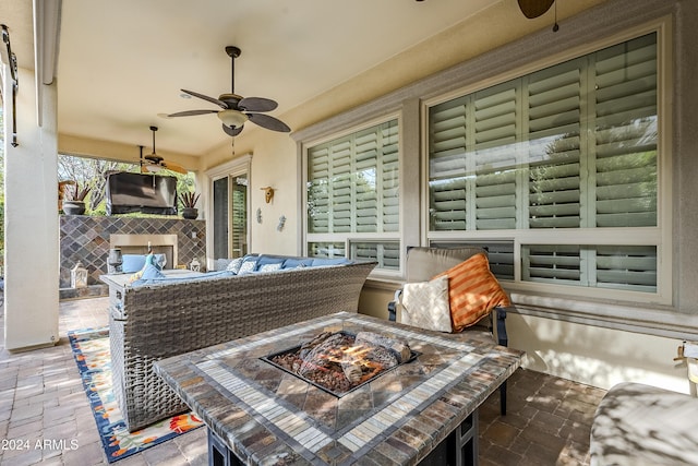 view of patio / terrace featuring ceiling fan and an outdoor fire pit