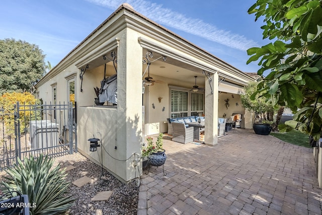 exterior space with ceiling fan and an outdoor living space