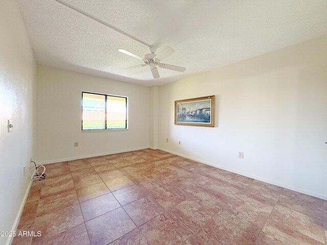 10330 W Thunderbird Blvd Unit C304, Sun City, AZ 85351 - tiled empty room featuring a textured ceiling, a ceiling fan, and baseboards