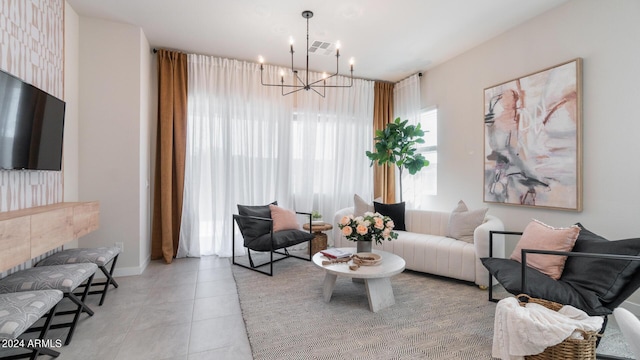 living room with light tile patterned floors, visible vents, and a chandelier