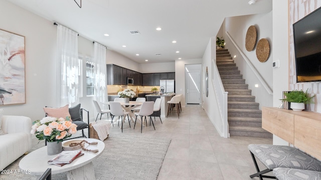 living area with stairs, light tile patterned floors, recessed lighting, and visible vents