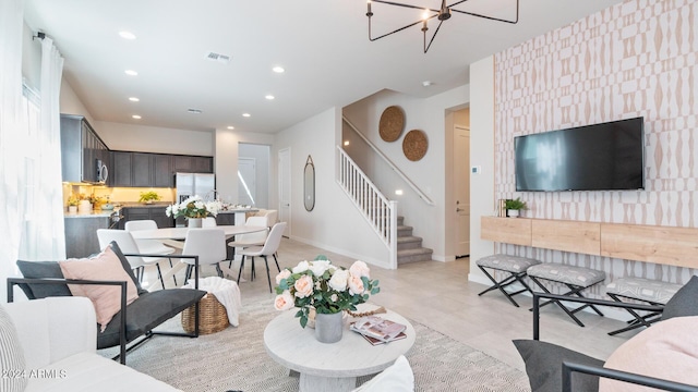 living room with stairway, visible vents, baseboards, recessed lighting, and a notable chandelier