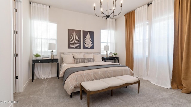 carpeted bedroom featuring a notable chandelier