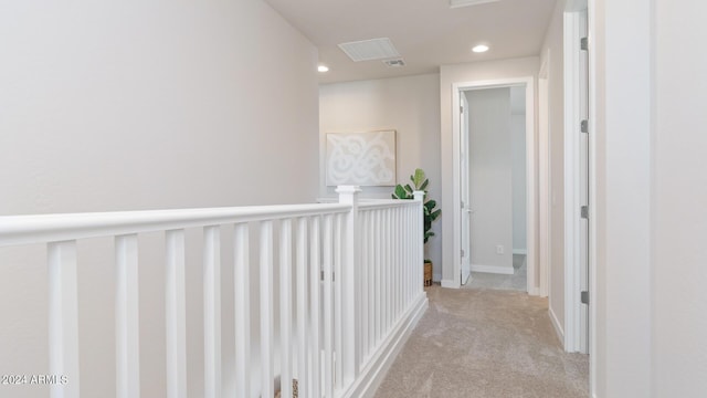 hallway with light carpet, recessed lighting, and baseboards