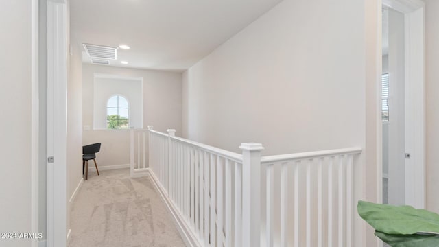 hall featuring visible vents, baseboards, carpet floors, an upstairs landing, and recessed lighting